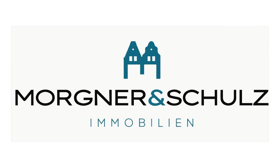 Logo der Firma Morgner & Schulz mit stilisierten H&auml;usern und dem Schriftzug &bdquo;IMMOBILIEN&ldquo;.